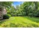 Expansive lush green backyard features mature trees and landscaping at 10965 Fairway Ridge Ln, Fishers, IN 46037