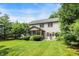 Exterior of home with a screened porch and patio, surrounded by a lush lawn and trees at 10965 Fairway Ridge Ln, Fishers, IN 46037