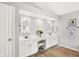 Bright bathroom with double vanities, mirrors, and wood look tile at 10965 Fairway Ridge Ln, Fishers, IN 46037