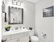 Powder room featuring a mirror, sink, toilet and contemporary light fixtures at 10965 Fairway Ridge Ln, Fishers, IN 46037