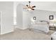 Neutral bedroom with a ceiling fan and ensuite bath at 10965 Fairway Ridge Ln, Fishers, IN 46037