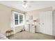 A bright bedroom with a window, neutral walls, and a white dresser at 10965 Fairway Ridge Ln, Fishers, IN 46037