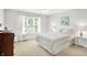 Bright bedroom with a large window, neutral walls, and a queen-sized bed at 10965 Fairway Ridge Ln, Fishers, IN 46037