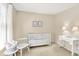 A charming Bedroom with a white crib, a window with blinds, and neutral decorations at 10965 Fairway Ridge Ln, Fishers, IN 46037