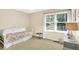 A cozy bedroom with a daybed, a window, and neutral decor at 10965 Fairway Ridge Ln, Fishers, IN 46037