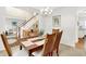 Dining room with hardwood table, views to the foyer and living room, and chandelier at 10965 Fairway Ridge Ln, Fishers, IN 46037