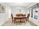 Well-lit dining room featuring a chandelier and natural light from the nearby window at 10965 Fairway Ridge Ln, Fishers, IN 46037