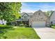 Charming two-story home with brick accents, attached garage, and a well-manicured lawn on a bright day at 10965 Fairway Ridge Ln, Fishers, IN 46037