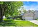 Charming two-story home with brick accents, attached garage, and a well-manicured lawn on a bright day at 10965 Fairway Ridge Ln, Fishers, IN 46037