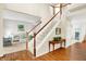 Open foyer with a staircase, hardwood floors, and a view of the living room, creating an inviting entry at 10965 Fairway Ridge Ln, Fishers, IN 46037