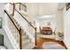 Bright foyer with staircase and dining room, hardwood floors and neutral color palette at 10965 Fairway Ridge Ln, Fishers, IN 46037