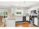 Eat-in kitchen featuring stainless steel appliances and a breakfast bar, with access to the outdoors at 10965 Fairway Ridge Ln, Fishers, IN 46037