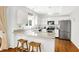 Bright kitchen with stainless steel appliances, granite countertops, and a breakfast bar at 10965 Fairway Ridge Ln, Fishers, IN 46037
