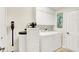 Functional laundry room featuring a washer, a dryer, and ample storage space at 10965 Fairway Ridge Ln, Fishers, IN 46037