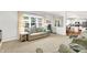 Bright living room with large windows, hardwood floors, and views to the kitchen at 10965 Fairway Ridge Ln, Fishers, IN 46037