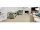 Bright living room showcasing a fireplace, cozy armchairs, and a plush sofa at 10965 Fairway Ridge Ln, Fishers, IN 46037