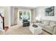 Bright living room with neutral carpet, comfortable seating, and large windows providing ample natural light at 10965 Fairway Ridge Ln, Fishers, IN 46037