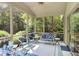 Spacious screened porch with stylish seating, side tables, and scenic backyard views at 10965 Fairway Ridge Ln, Fishers, IN 46037