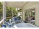 Comfortable screened porch with a ceiling fan and sliding door access to the home's interior at 10965 Fairway Ridge Ln, Fishers, IN 46037