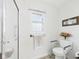 Bright bathroom featuring a walk-in shower with glass doors and safety features at 1108 Northfield Ln, Anderson, IN 46011