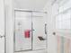 Bright bathroom featuring a walk-in shower with glass doors and safety features at 1108 Northfield Ln, Anderson, IN 46011