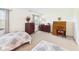 Carpeted bedroom featuring twin beds, a dresser, and a desk area with lots of light at 1108 Northfield Ln, Anderson, IN 46011