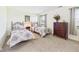 This bedroom features two twin beds, a dark wood dresser, and a window for natural light at 1108 Northfield Ln, Anderson, IN 46011