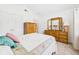 Bright bedroom with vaulted ceiling, closet, and a full-length mirror on the dresser at 1108 Northfield Ln, Anderson, IN 46011