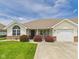 Charming ranch home featuring a manicured lawn, covered porch and attached garage at 1108 Northfield Ln, Anderson, IN 46011
