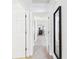 Hallway leading into a carpeted bedroom and a mirror on the wall at 1108 Northfield Ln, Anderson, IN 46011