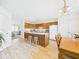 Well-lit kitchen with a large island, wooden cabinetry and open layout to the dining area at 1108 Northfield Ln, Anderson, IN 46011