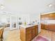Cozy kitchen with island, eat-in bar, wood cabinets and view into living area at 1108 Northfield Ln, Anderson, IN 46011
