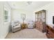 Comfortable sitting area with armchairs, end table, and a built-in display cabinet at 1108 Northfield Ln, Anderson, IN 46011