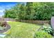Well-manicured backyard featuring lush lawn, mulch beds, and a sturdy wood fence for added privacy at 11437 High Grass Dr, Indianapolis, IN 46235