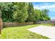 Backyard featuring a concrete patio and a well-maintained lawn area, enclosed by a tall wooden fence at 11437 High Grass Dr, Indianapolis, IN 46235