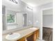 Bright bathroom features a dual vanity, large mirror, and an adjacent room, offering convenience at 11437 High Grass Dr, Indianapolis, IN 46235