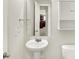 Bathroom featuring a pedestal sink, toilet, and mirrored wall cabinet at 11437 High Grass Dr, Indianapolis, IN 46235