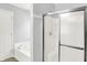 Bright bathroom featuring white tub, shower with a glass door and a towel hook at 11437 High Grass Dr, Indianapolis, IN 46235