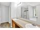 Bright bathroom featuring double sinks, tub, and shower with a glass door at 11437 High Grass Dr, Indianapolis, IN 46235