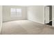 Spacious carpeted bedroom features a large window for natural light, offering a serene retreat at 11437 High Grass Dr, Indianapolis, IN 46235