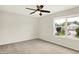 Bedroom featuring neutral carpet, ceiling fan and view to neighborhood at 11437 High Grass Dr, Indianapolis, IN 46235
