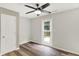 Bedroom featuring wood-look floors, ceiling fan, and back yard access at 11437 High Grass Dr, Indianapolis, IN 46235