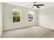 Bedroom featuring neutral carpet, ceiling fan and view to neighborhood at 11437 High Grass Dr, Indianapolis, IN 46235