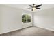 Bedroom featuring neutral carpet, ceiling fan and view to neighborhood at 11437 High Grass Dr, Indianapolis, IN 46235