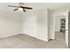 Bedroom featuring neutral carpet, ceiling fan and white closet doors at 11437 High Grass Dr, Indianapolis, IN 46235