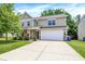 Inviting two-story home with a spacious driveway, manicured lawn, and traditional curb appeal at 11437 High Grass Dr, Indianapolis, IN 46235