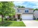 Charming two-story home featuring a well-maintained lawn, an attached garage, and tasteful landscaping at 11437 High Grass Dr, Indianapolis, IN 46235