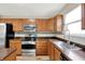 View of the kitchen showing ample cabinets, stainless steel appliances, and tiled backsplash at 11437 High Grass Dr, Indianapolis, IN 46235