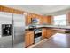 Kitchen view showcasing stainless steel refrigerator, microwave, oven, and sink at 11437 High Grass Dr, Indianapolis, IN 46235