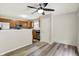 Kitchen featuring oak cabinets, stainless steel appliances, tile backsplash, and view to an adjacent living room at 11437 High Grass Dr, Indianapolis, IN 46235